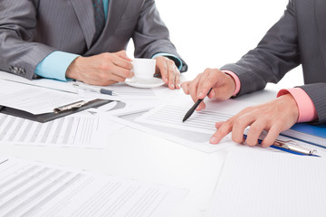 Business people in elegant suits sitting at desk handshake