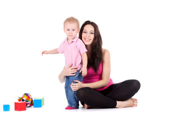 Fototapeta na wymiar young mother with son play build blocks