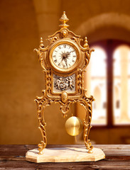 ancient vintage golden brass pendulum clock