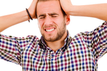 Close up of a young man having a intense headache. Isolated over