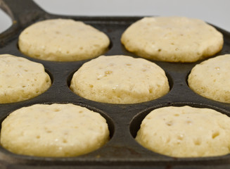 A Batch of Aebelskivers Cooking in a Pan