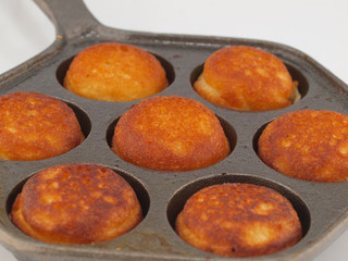 A Pan of Freshly Cooked Aebelskivers Awaiting Garnish