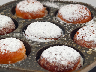 A Pan of Freshly Cooked Aebelskivers with Powdered Sugar