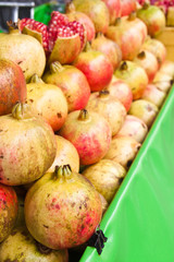 Row of pomegranate fruits.