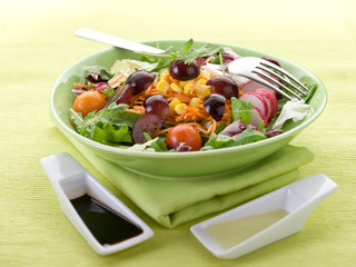 mixed salad with slice grapes carrot, arugula,maize and green sa