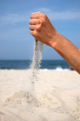 Sand falling from the man's hand - 35755237