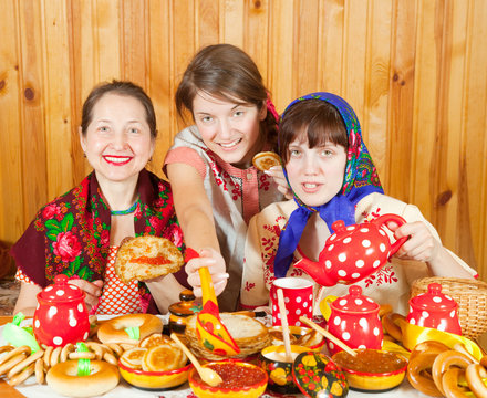 Women eating pancake with caviare during  Shrovetide