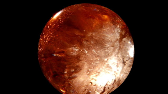 Crystal ball, gold moonstone on black background