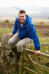 Man jumping over country gate