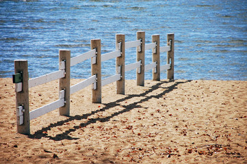 Wooden fence on sandy beach