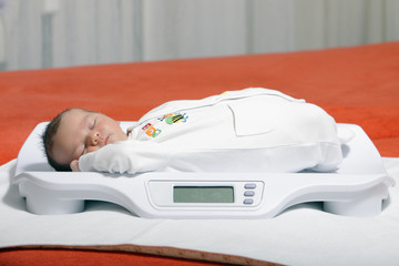 baby boy on weight scale