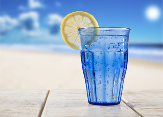 a Blue glass with sparkling water and lemon