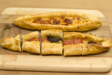 Turkish food pide, yeast dough cheese and butter.