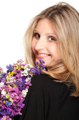 Naklejka premium Blonde woman turning with bouquet of field flowers