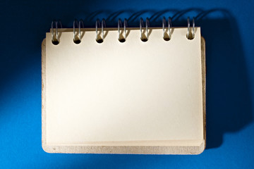 Notepad isolated on blue background