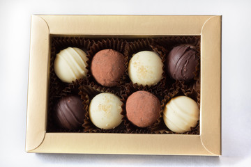 A golden box with eight assorted chocolates