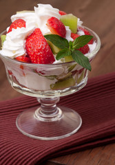 strawberries and kiwi on a table.