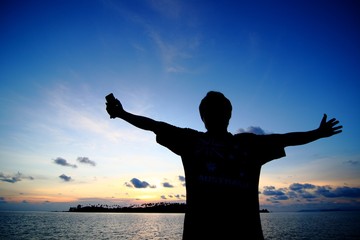 Man silhouette and blue sky in the Evening