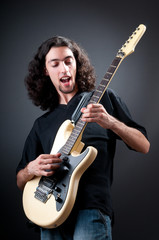 Obraz premium Guitar player against the dark background