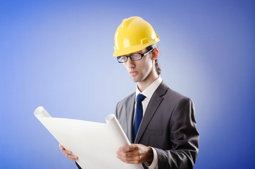 Young architect with drawings and hardhat