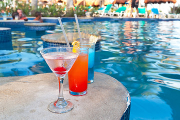 Tropical drinks at swimming pool on holidays