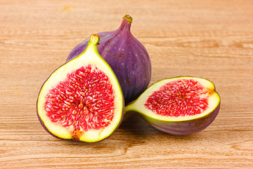 Ripe figs on wooden background
