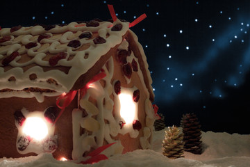 Closeup gingerbread cottage with stars in the background