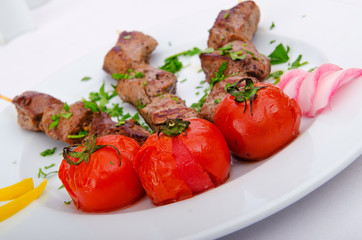 Kebab and tomatoes in the plate