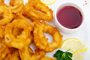 Fried calamari rings served with sauce
