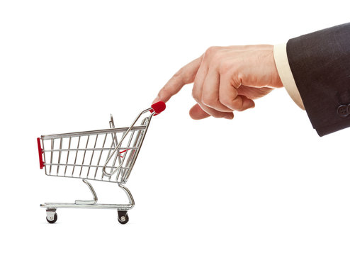 businessman's hand pushes shopping cart