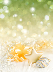 Gold and silver Christmas baubles on background of defocused gol