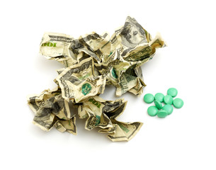 Crumpled american money and pills