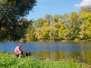 Senior fisherman catches a fish