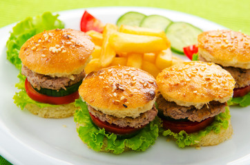 Plate with tasty mini burgers