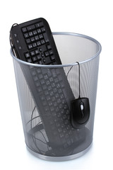 Old PC keyboard and mouse in metal trash bin  isolated on  white