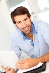 Portrait of office worker using electronic tablet