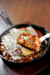 Japanese pizza on a pan.