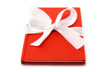 Notepad with white bow on a white background