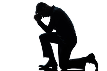 silhouette man kneeling sadness praying full length - 35795670