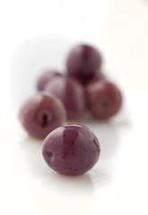 Olives in brine on white background.
