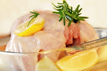 raw chicken with rosemary and lemon