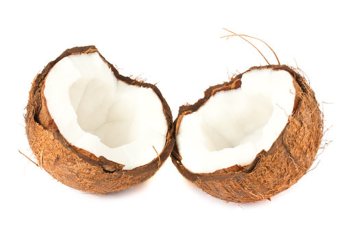 Two halves of coconut on white background