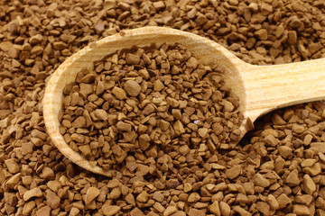 Ground coffee with wooden spoon close-up