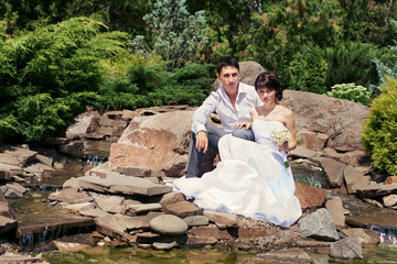 Bride and groom posing in garden