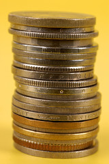 Foreign coins on yellow background