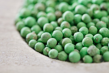 green peppercorn in wooden bowl, shallow dof