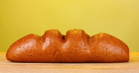 rye bread on wooden table on yellow background