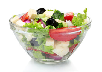 Tasty greek salad in transparent bowl isolated on white