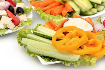 Sliced â€‹â€‹vegetables and Greek salad on plate closeup