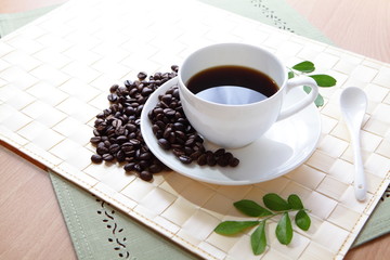 Coffee bean and hot coffee with green leaf